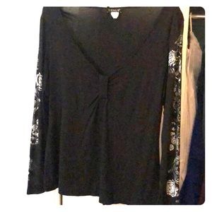 Black top with silver flower sleeves.
